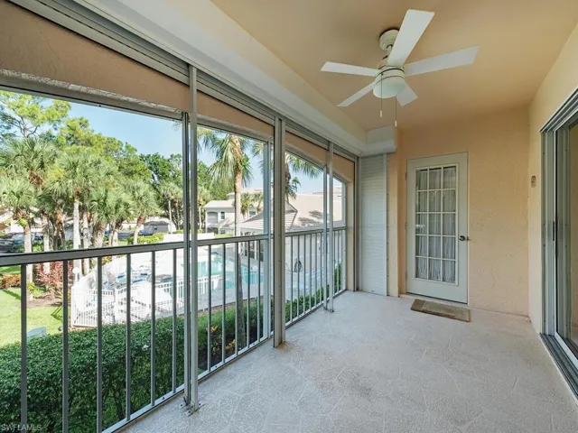 Unfurnished sunroom featuring ceiling fan