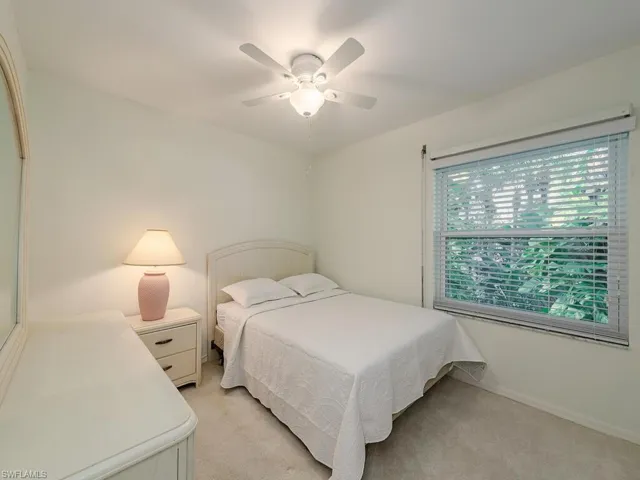 Carpeted bedroom with ceiling fan