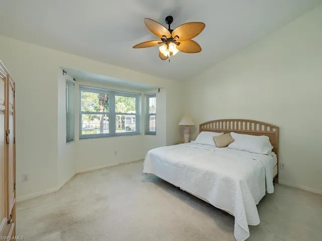 Bedroom featuring ceiling fan and light colored carpet