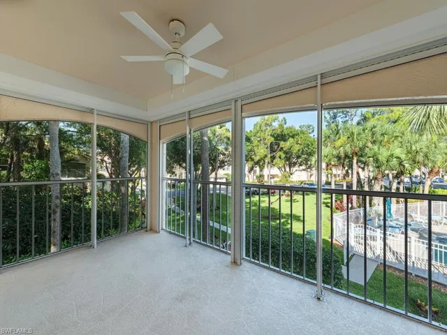 Unfurnished sunroom with ceiling fan