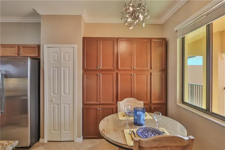 Dining room featuring a chandelier, crown molding, and light tile patterned floors