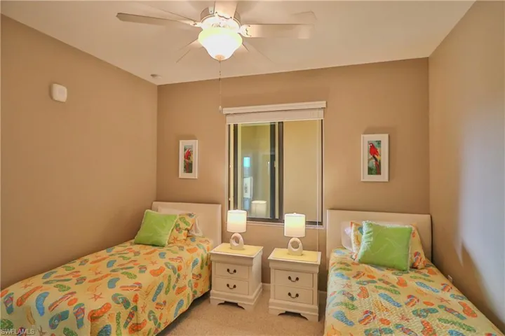 Carpeted bedroom featuring ceiling fan