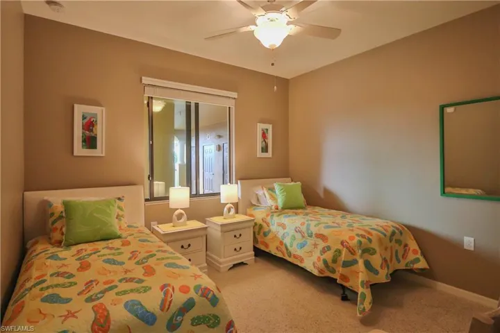 Bedroom featuring light carpet and ceiling fan