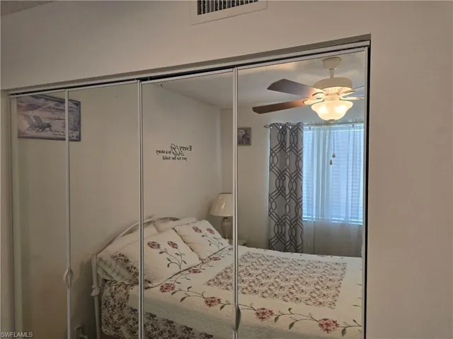 Bedroom featuring ceiling fan, a closet, and visible vents