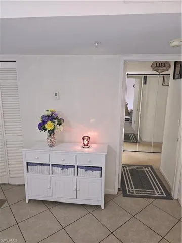 Corridor featuring baseboards and light tile patterned floors