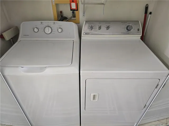 Laundry room with washing machine and clothes dryer