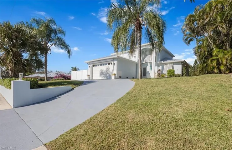This lovely two-story home sits 17' above sea level and is fully shuttered on all openings