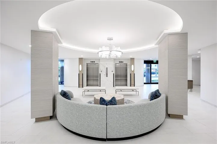Living room with elevator and a chandelier