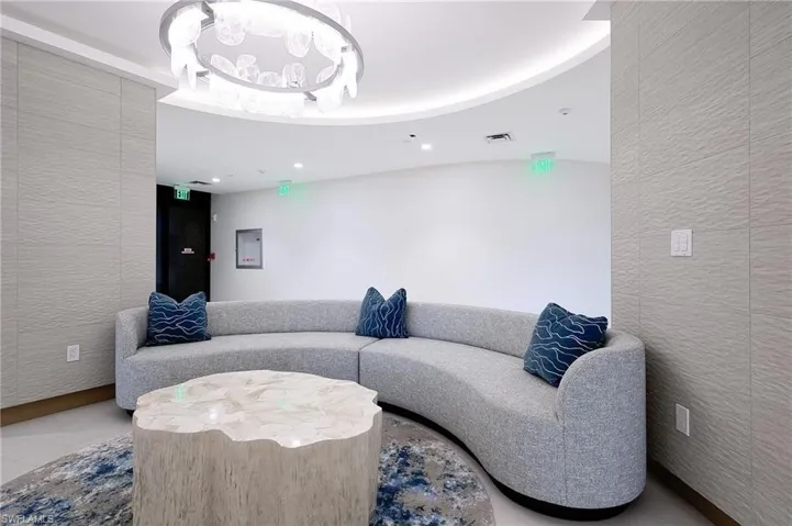 Common area with recessed lighting and a textured wall