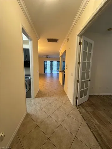 Entry hallway looking back towards living room, kitchen, master bedroom and pool