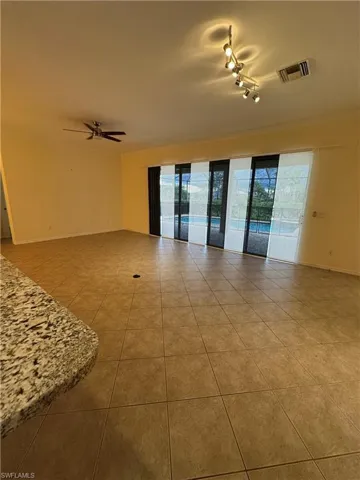 Living Room looking out to covered lanai and pool