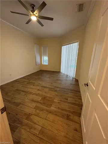 Master bedroom with sliders to the pool and lanai