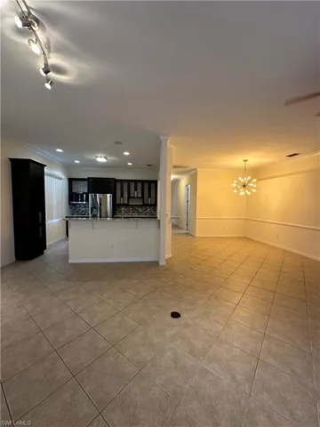 Living room looking into the kitchen on the left and dining area on the right