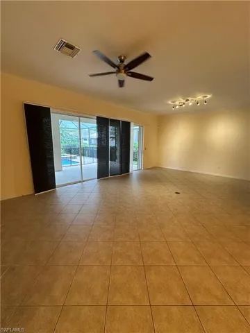 Living room with adjustable shades and overhead lighting and fans