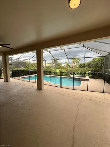 Large under truss area of the lanai looking over the pool and hot tub