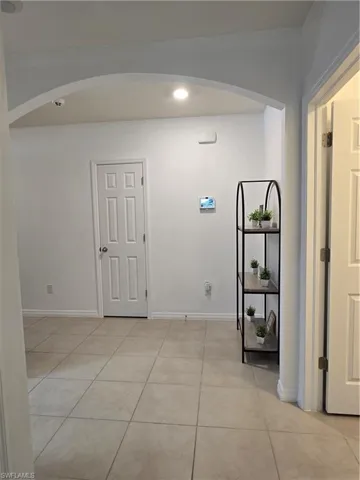 Corridor with light tile patterned floors