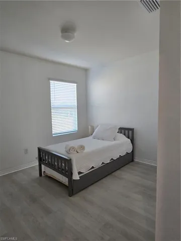 Bedroom featuring wood-type flooring