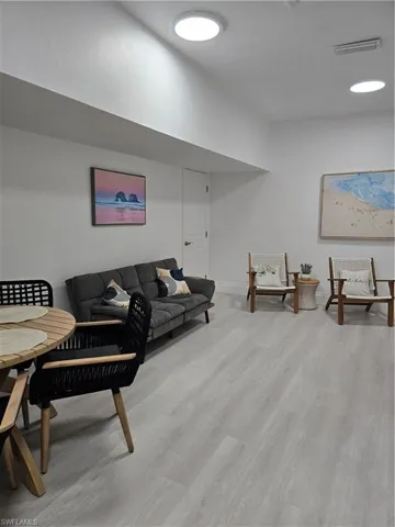 Living room with light hardwood / wood-style flooring