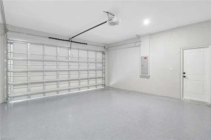 Garage with electric panel and a garage door opener