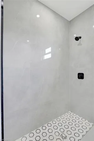 Full bath featuring a tile shower