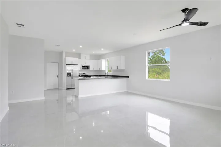 Unfurnished living room featuring recessed lighting, a ceiling fan, and light tile patterned flooring