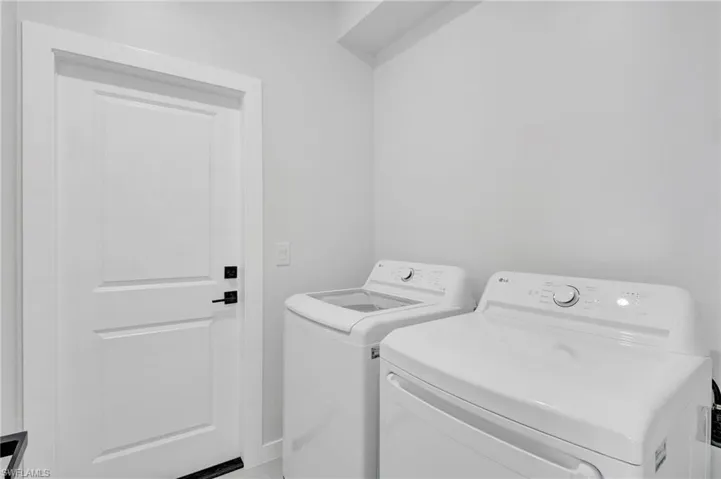 Laundry room featuring washer and clothes dryer