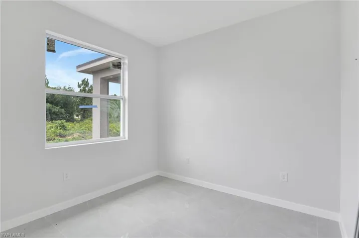 Unfurnished room featuring baseboards and light tile patterned floors
