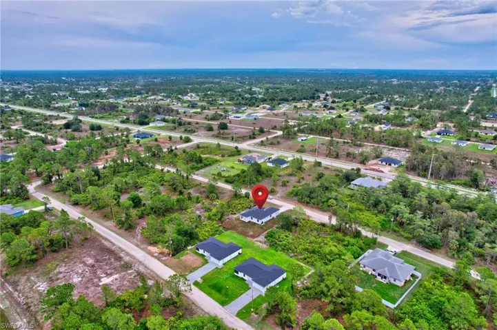 Aerial view of residential area featuring a tree filled landscape