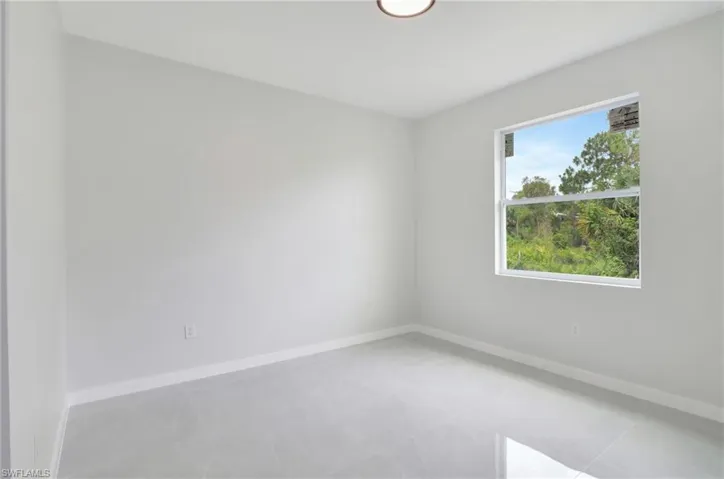 Unfurnished room featuring light tile patterned floors