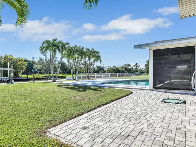 View of pool featuring a lawn