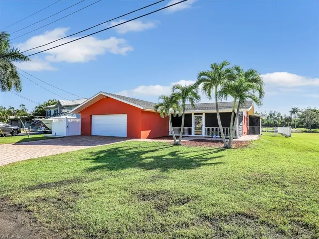 Single story home with covered porch, a garage, and a front yard