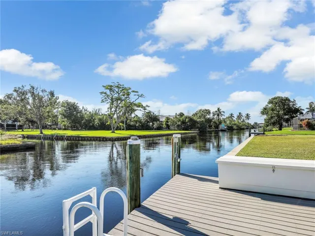 View of dock featuring a water view and a yard