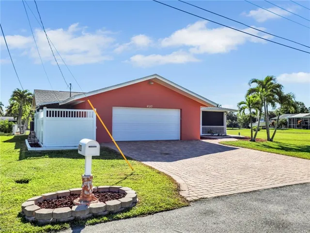 Ranch-style house with a front yard and a garage