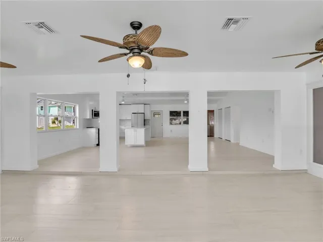 Unfurnished living room with ceiling fan