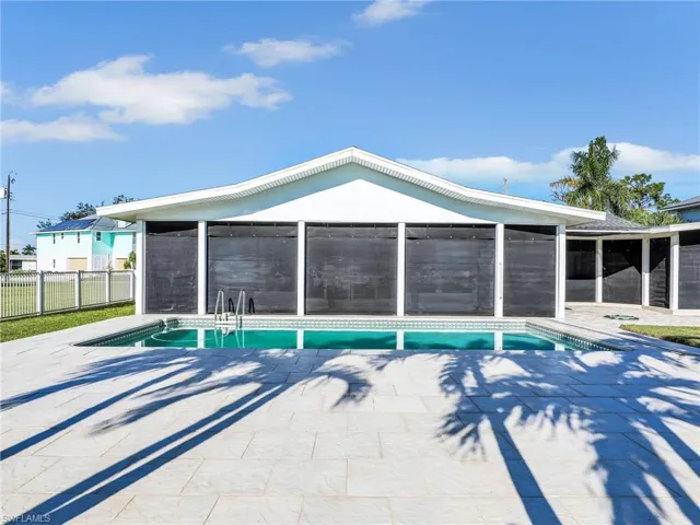 View of pool with a patio area and a sunroom