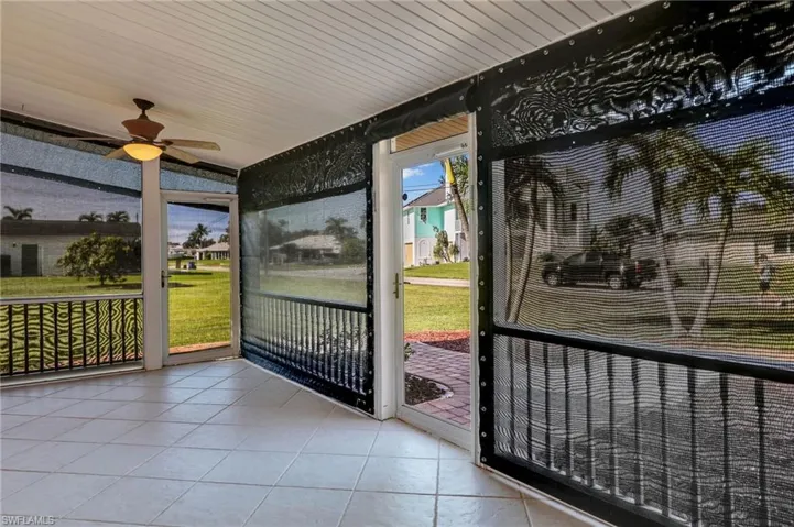 Sunroom / solarium with ceiling fan and wooden ceiling