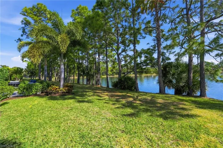 View of green lawn featuring a water view