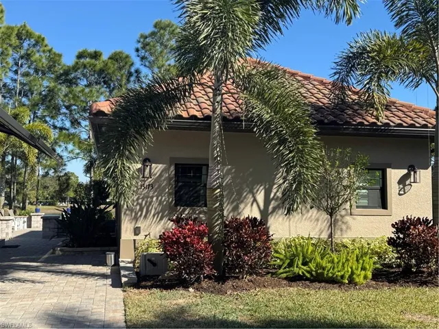 View of front of house featuring a front yard and decorative driveway