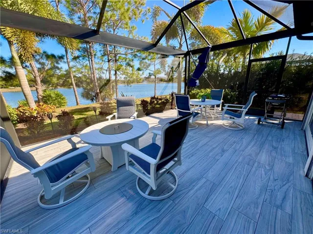Sunroom / solarium with a water view and plenty of natural light