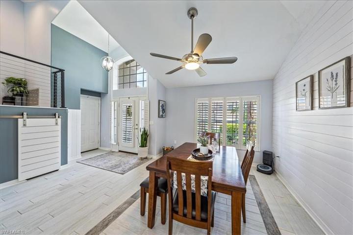 The dining room is located just off of the foyer with direct kitchen access and features a vaulted ceiling and decorative nickel gap/shiplap wall treatment.