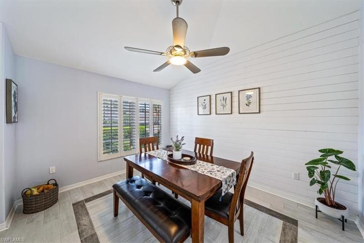 The dining room is located just off of the foyer with direct kitchen access and features a vaulted ceiling and decorative nickel gap/shiplap wall treatment.
