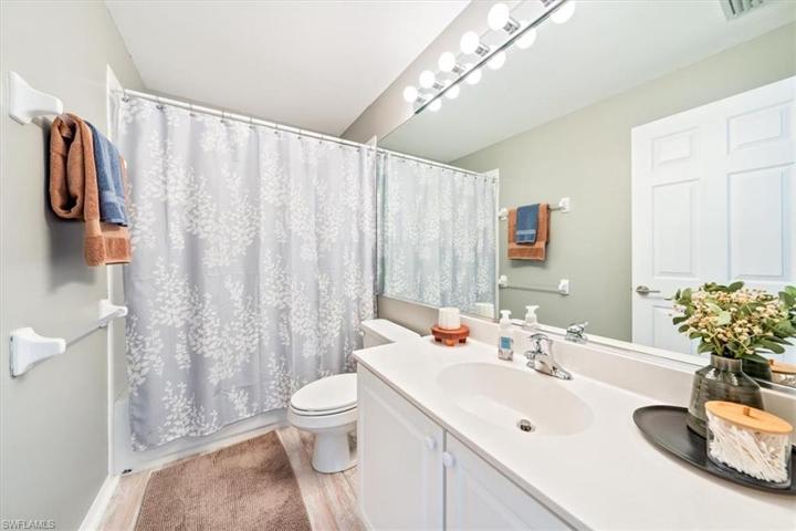 The second floor guest bathroom features a tub/shower combo and vanity with ample storage below.