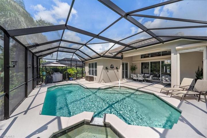 The screen enclosure provides a spacious retreat for swimming in the heated pool, soaking in the spa, grilling out, or lounging in the sun!