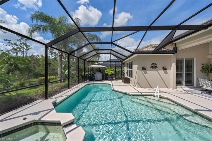 The screen enclosure provides a spacious retreat for swimming in the heated pool, soaking in the spa, grilling out, or lounging in the sun!