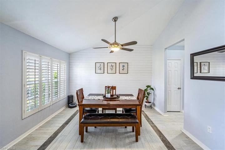 The dining room is located just off of the foyer with direct kitchen access and features a vaulted ceiling and decorative nickel gap/shiplap wall treatment.