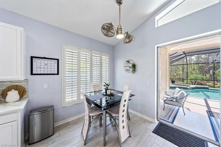 The breakfast nook just off of the kitchen overlooks the swimming pool and outdoor lounge area.
