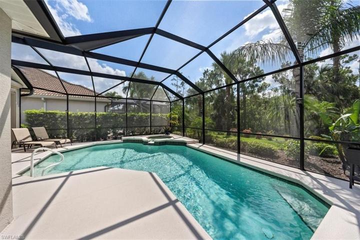 The screen enclosure provides a spacious retreat for swimming in the heated pool, soaking in the spa, grilling out, or lounging in the sun!