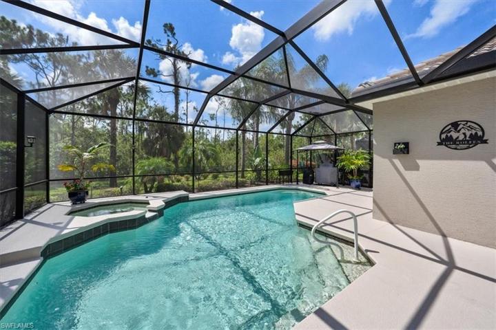 The screen enclosure provides a spacious retreat for swimming in the heated pool, soaking in the spa, grilling out, or lounging in the sun!