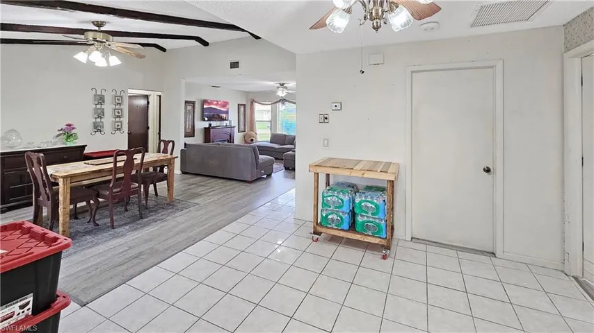 Tiled living room with beamed ceiling