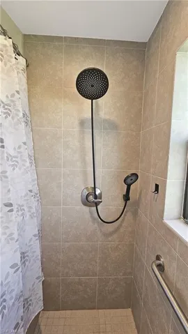 Bathroom featuring a shower with curtain